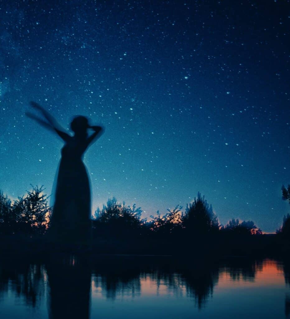 Woman pointing at starry sky