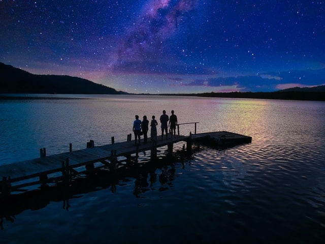 5 people on wharf at night