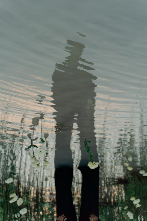 This reflection of a man in water represents looking within.