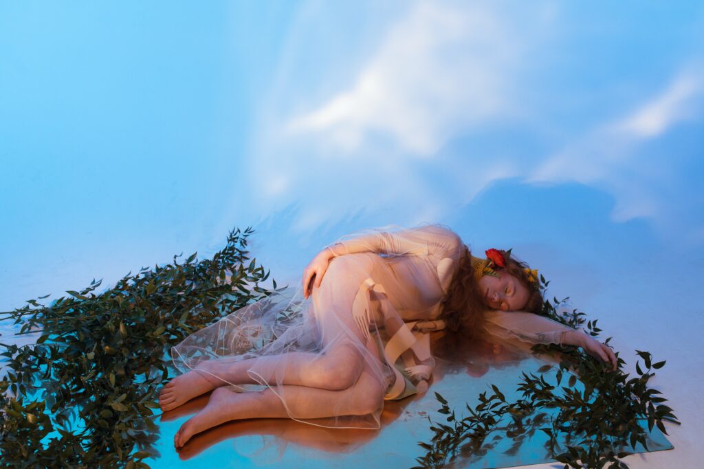 Woman dreaming in the clouds represents astrology and dream work.