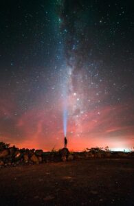 Man with light from head to stars represents the north node and seeking our life purpose.