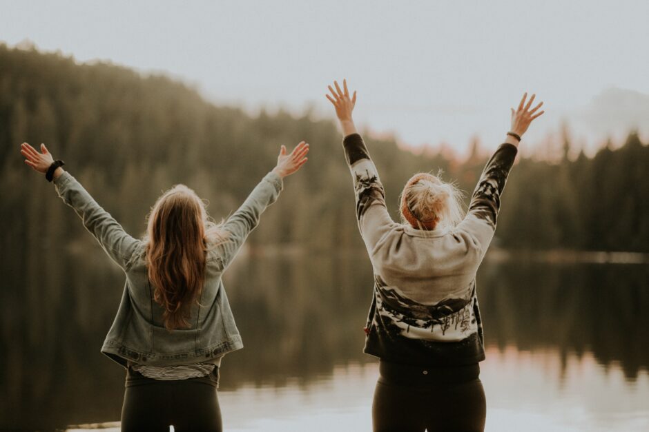 Two woman celebrating the beauty of nature symbolizes relationship astrology.