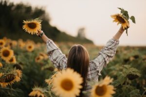Happy woman in sunflowers