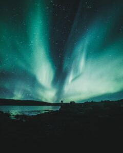 Green aurora borealis over the bay